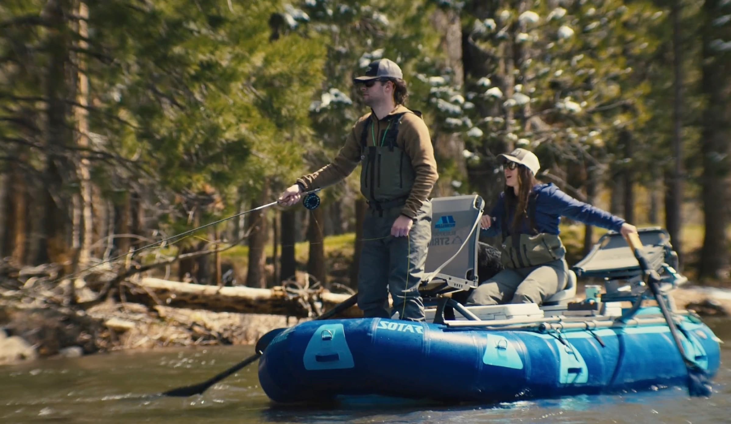 A guide casting from a drift boat while a client watches.